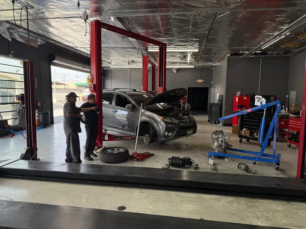 Performance truck in a lift bay at Velasco Auto Care Center